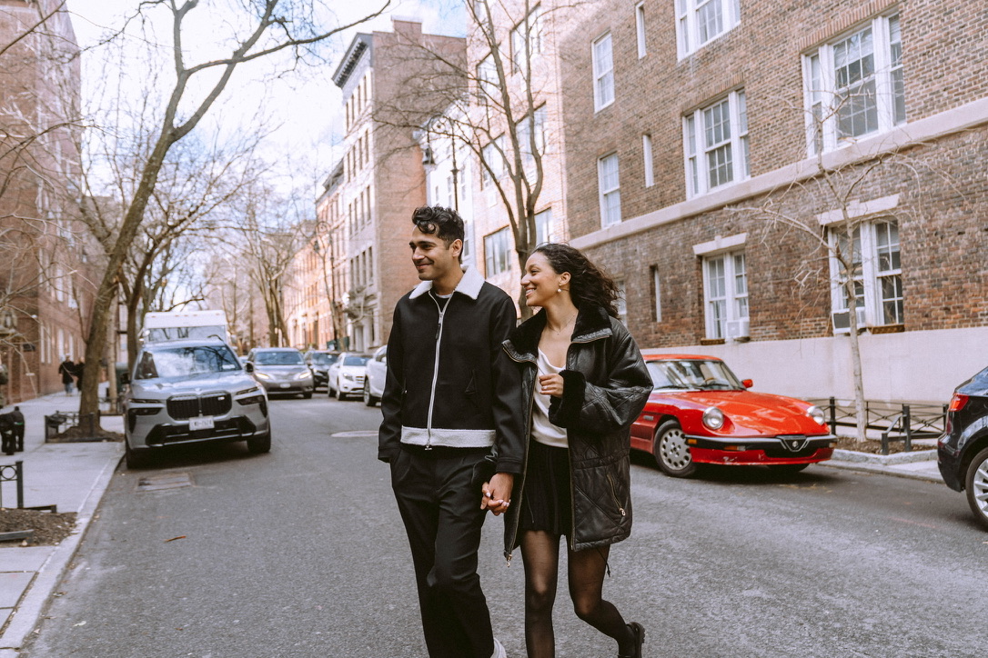 Arjun and Alexandra walking hand in hand on a city street