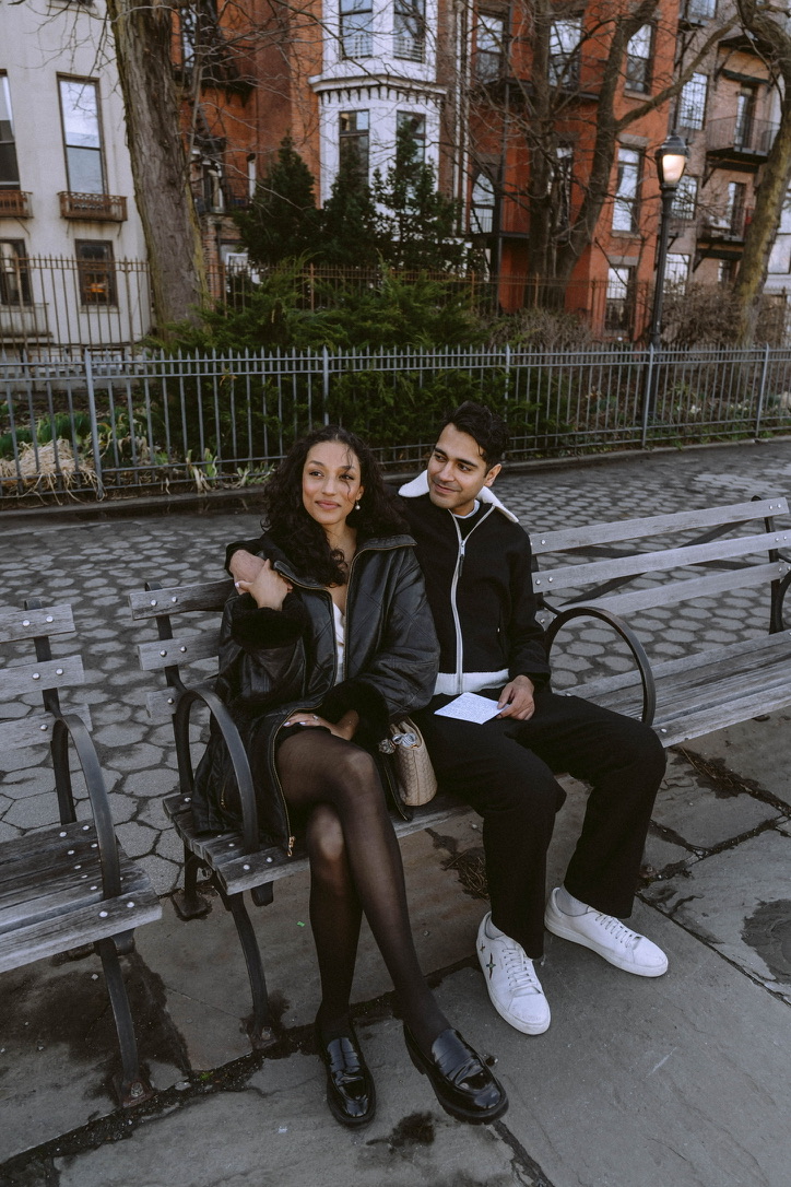 Arjun and Alexandra on a park bench in Brooklyn